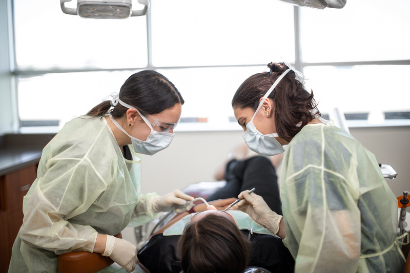 Dental students evaluating patient