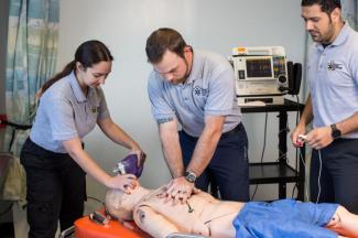 students practicing cpr on a dummy