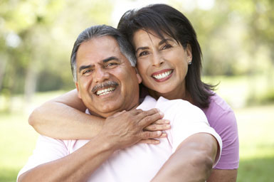 Two people smiling and hugging