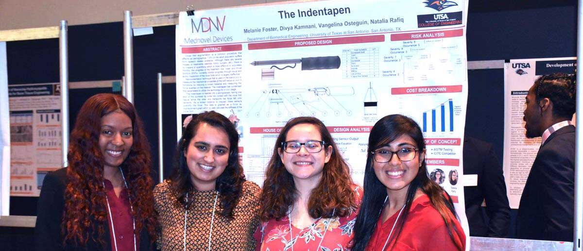 group of Biomedical Engineering, M.S. students standing in front of their medical poster at a symposium