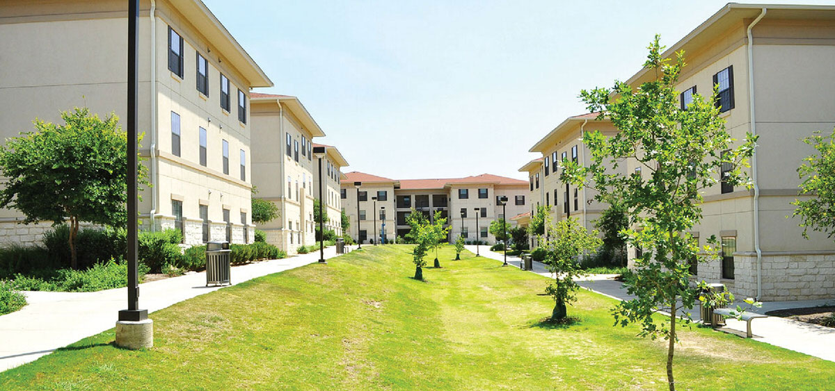 Image of financial aid housing units  and a green lush lawn scape