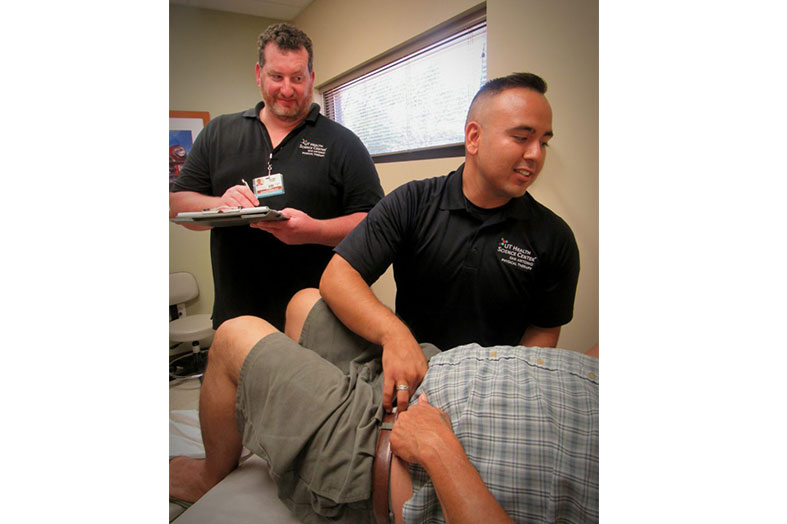 Physical therapy students treat a patient at Haven for Hope. 