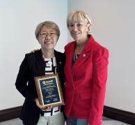 Communication Sciences and Disorders Chair and Associate Professor Fang-Ling Lu holds her Fellow of the Association of Schools Advancing Health Professions plaque, with ASAHP President Deb Larsen.