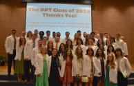 Doctor of Physical Therapy Class of 2025 poses in white coats