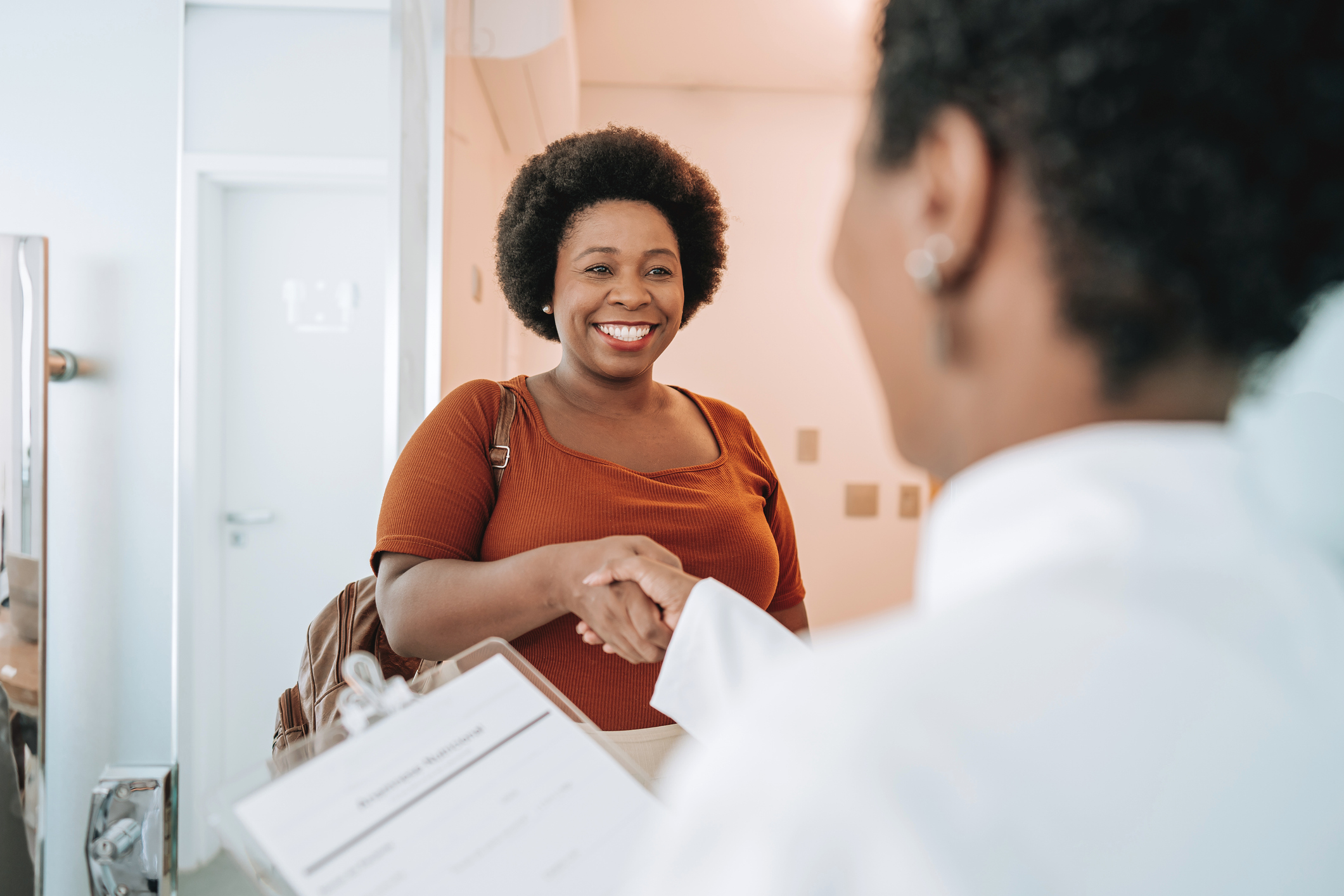 patient shaking hands with provider