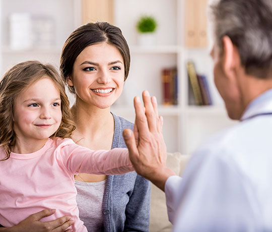 Doctor with child and her mother