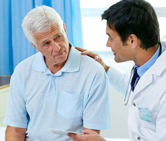 Male doctor with mature patient