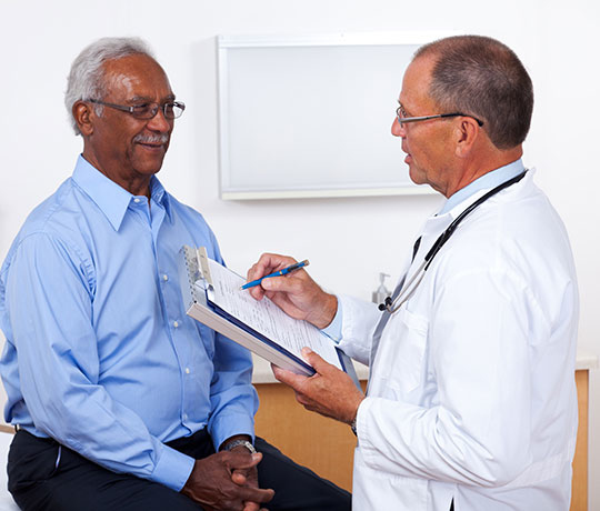 Male doctor with mature patient