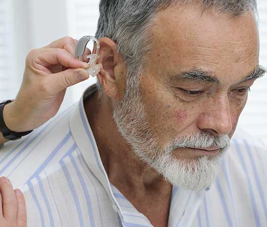Man getting fitted for hearing aids