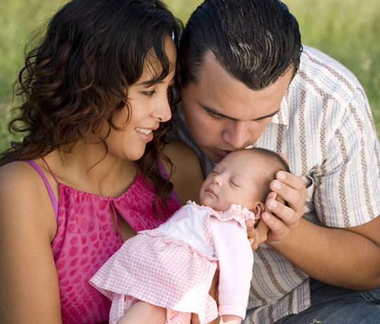 mother and father with baby