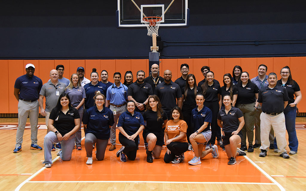 a group photo of a basketball team on the court