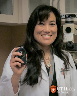 Dr. Osswald smiling in a photo wearing her white coat.
