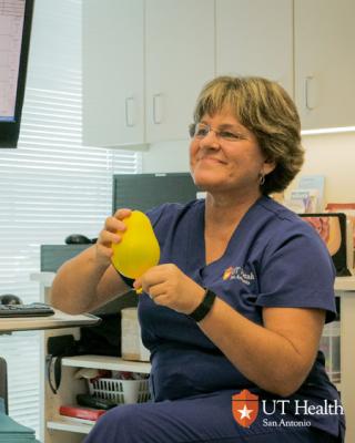 Nurse Betsy holding a balloon for a demonstration.
