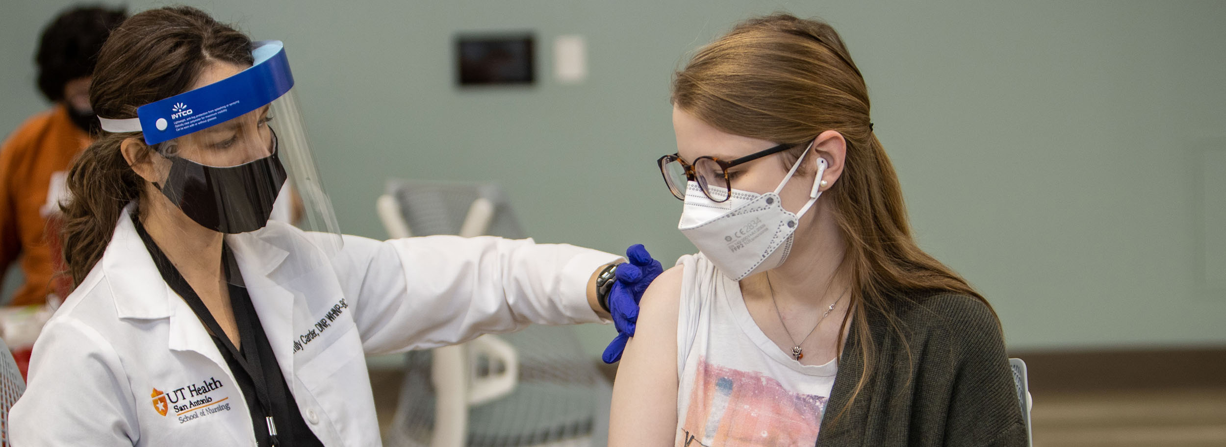 female student receiving vaccine