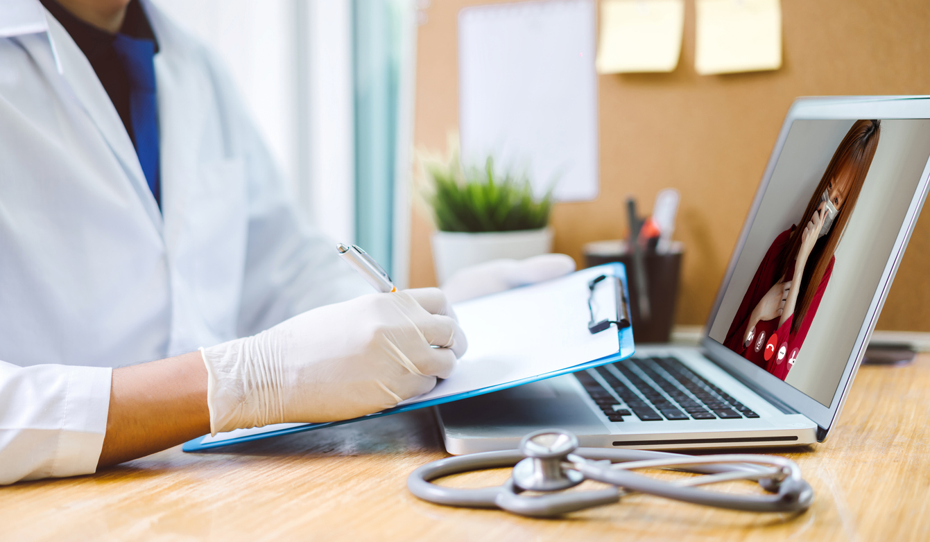 doctor conducts virtual visit with patient on a laptop