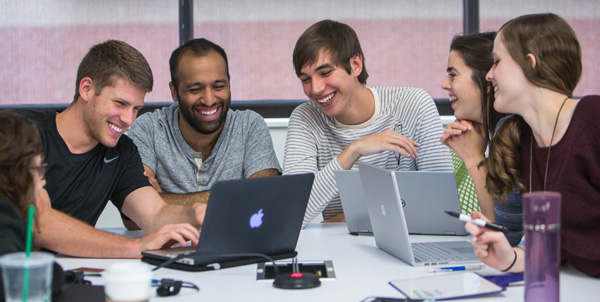 image of students laughing and talking together while studying