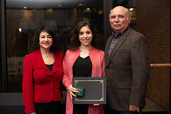 parents smiling with daughter