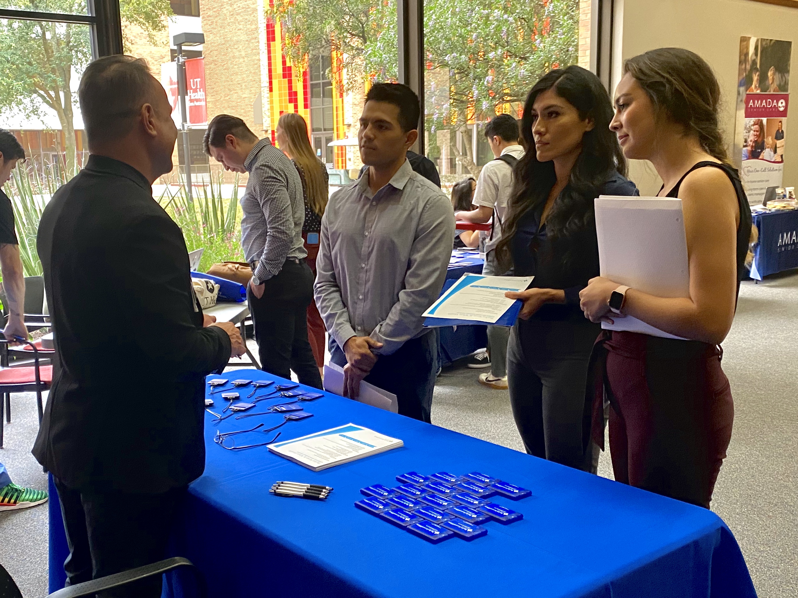 nursing students talk with recruiter at career fair