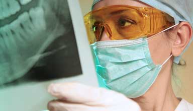 Dentist reviewing results of bone graft for dental implant approval