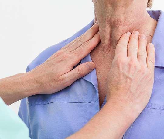 Doctor examining patient's neck