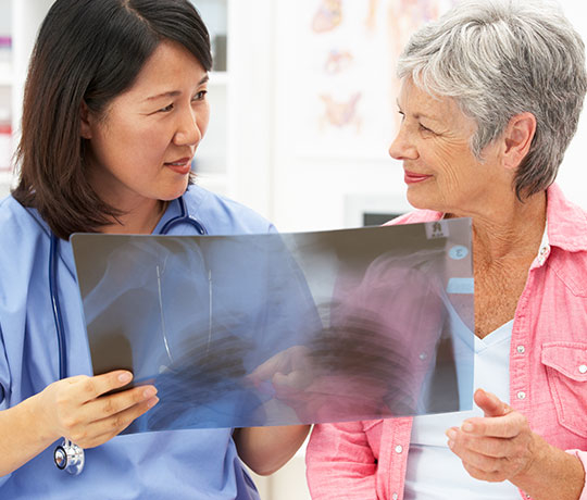 Physician consulting with older female patient