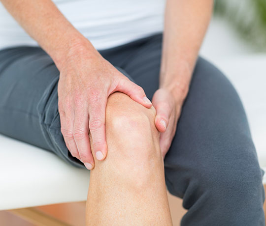 Patient holding knee