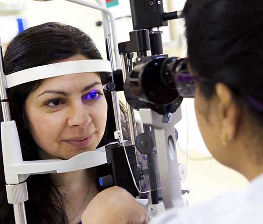 Female patient getting eyes examined