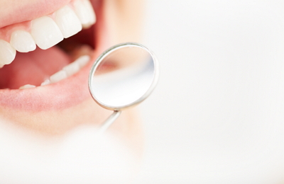 Patient getting examined after receiving gum recession treatment