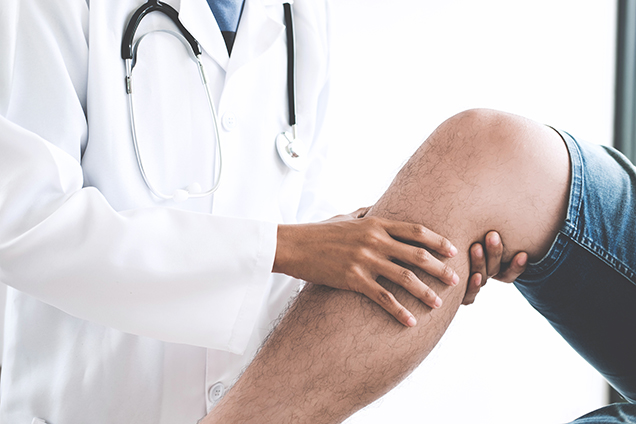 physician examining knee