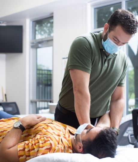 Orthopaedic doctor checking patient's mobility of arm
