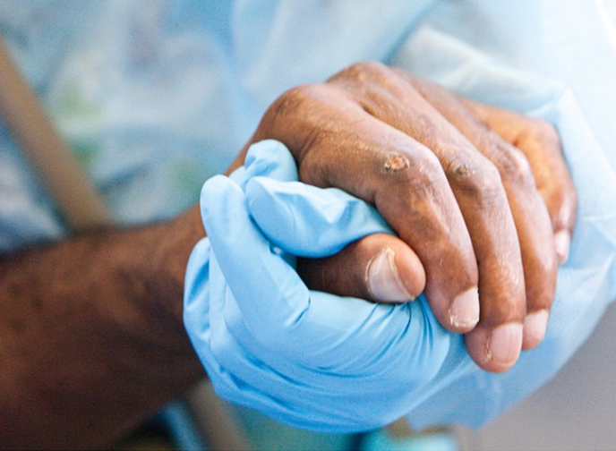 Patient hand being held