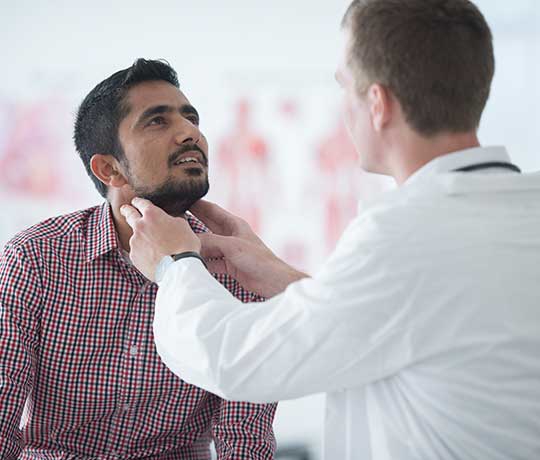 Physician examining a patient's neck