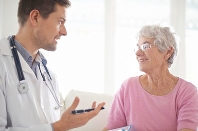 Gastroenterologist speaking with female patient