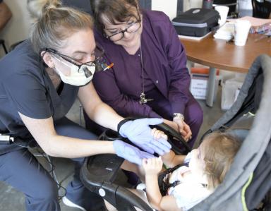 Dental student and faculty member provide dental screening at Haven for Hope.