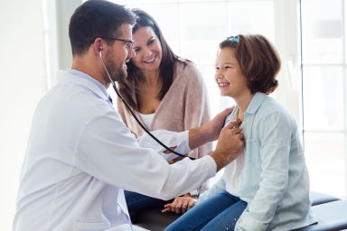 doctor with child patient and mother