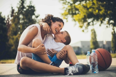 Mother and son playing basketball