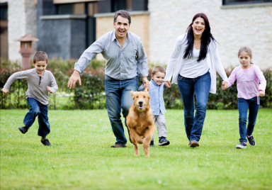Happy Family Chasing Dog