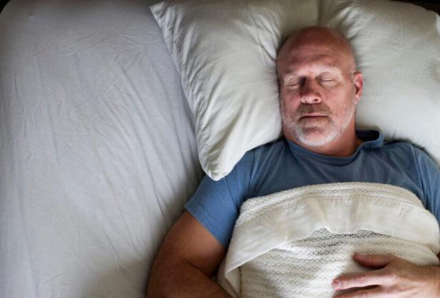 man sleeping in bed