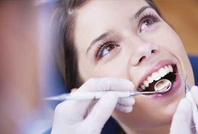 A dental specialist performing a dental evaluation on a patient