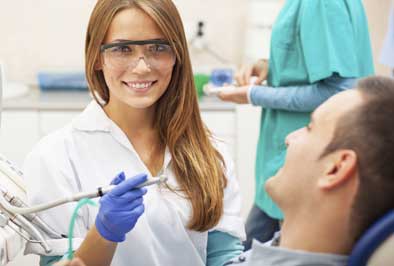 Periodontist performing a gum disease risk assessment on a dental patient