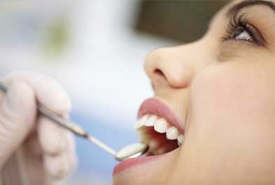 Dental patient being assessed after receiving pit and fissure sealants