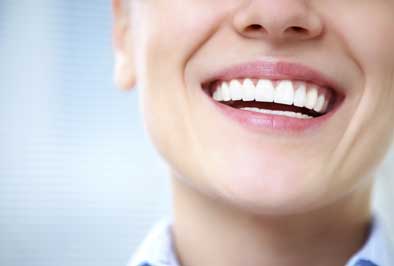 Dental patient's healthy smile after undergoing a pulp regeneration procedure