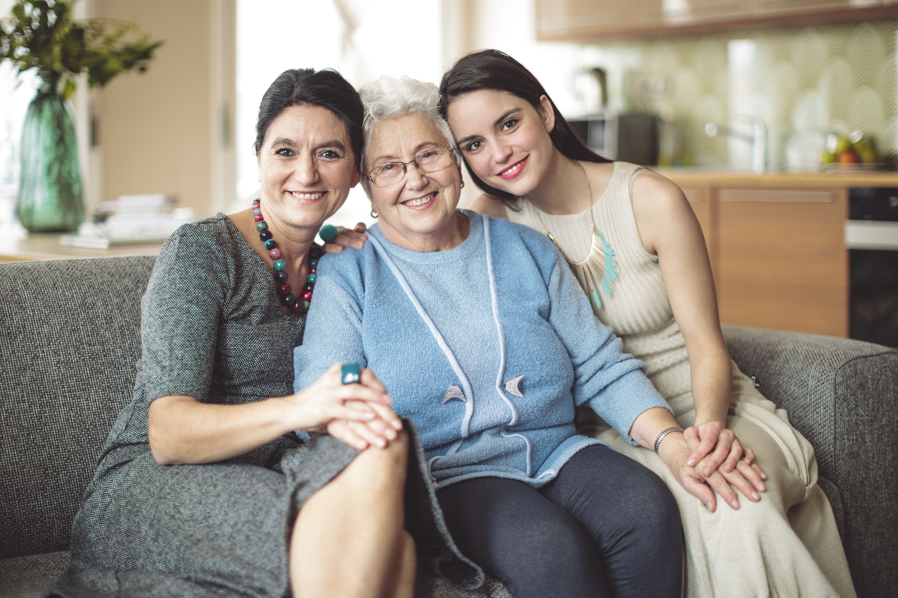 three women sitting smiling