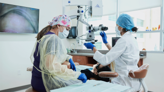 Endodontist and assistant with patient