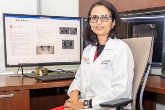 Dr. Katkar sitting at her desk
